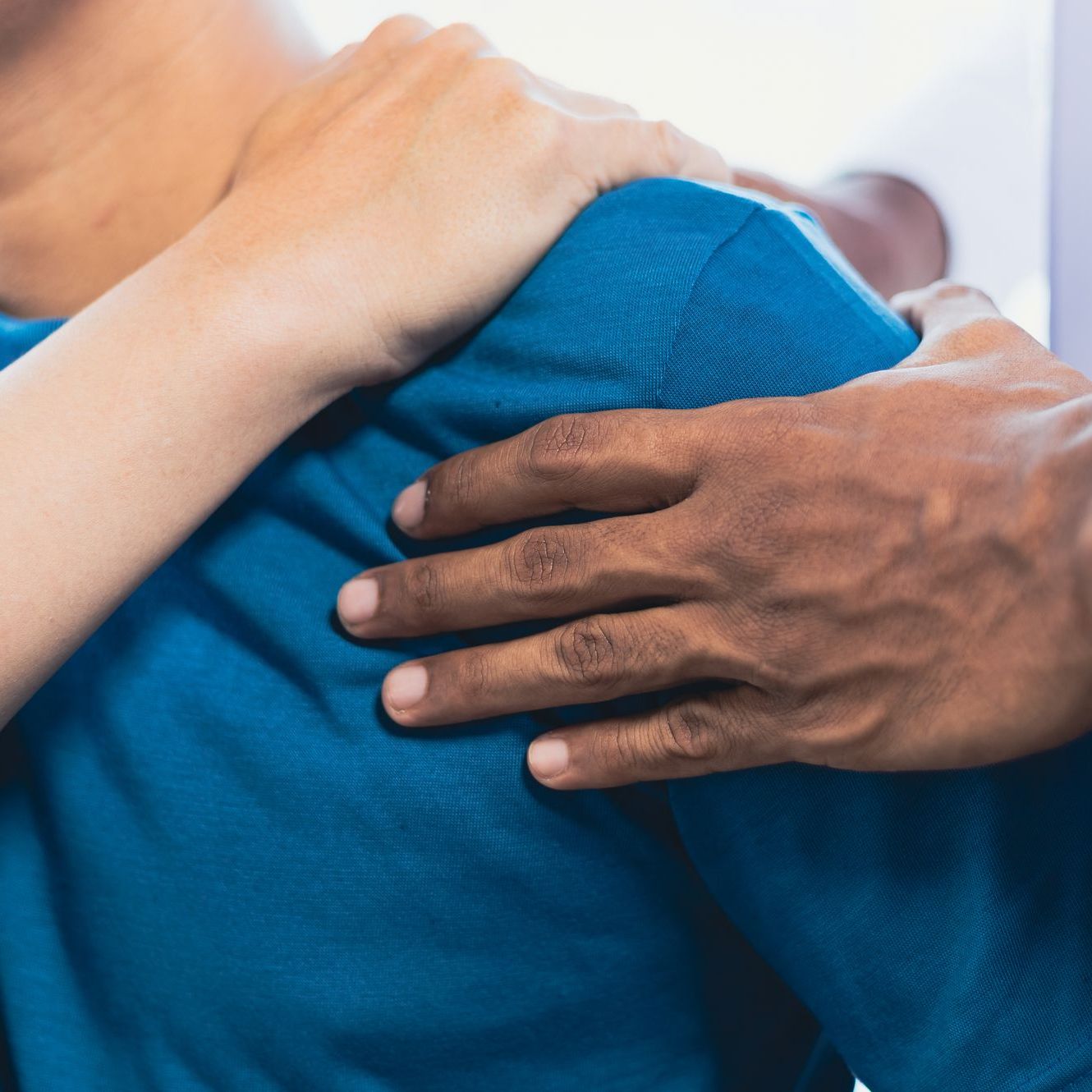 Doctor is diagnosing a man's arm and shoulder pain