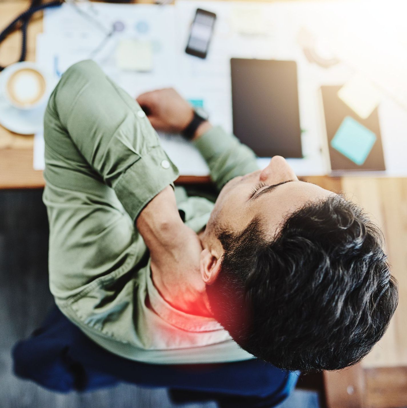 Man experiencing neck pain at desk Man experiencing neck pain at desk