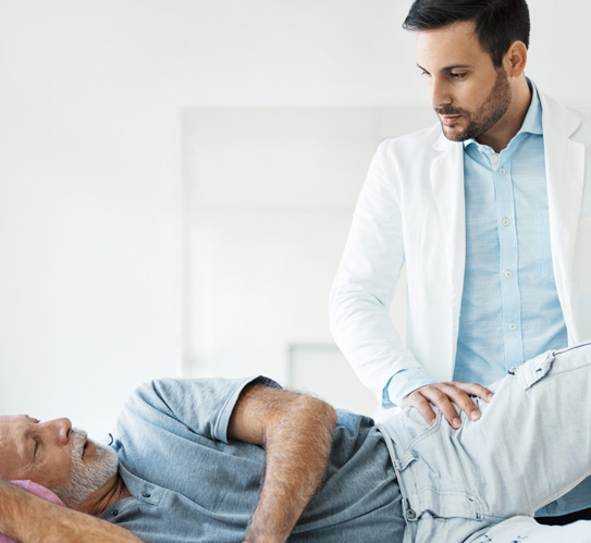 Doctor-examining-a-hip-of-a-senior-man