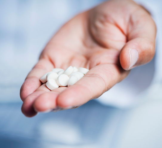 Doctor-hand-with-anti-inflammatory-tablets