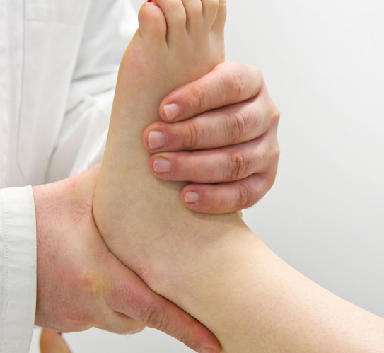Orthopedist-examining-a-woman's-foot