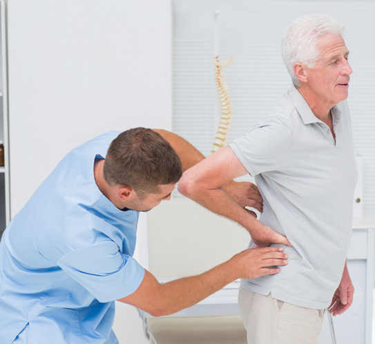 Physiotherapist-providing-a-back-massage-to-a-senior-man