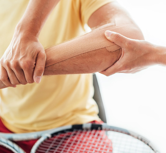 Tennis-player’s-elbow-taped-with-therapeutic