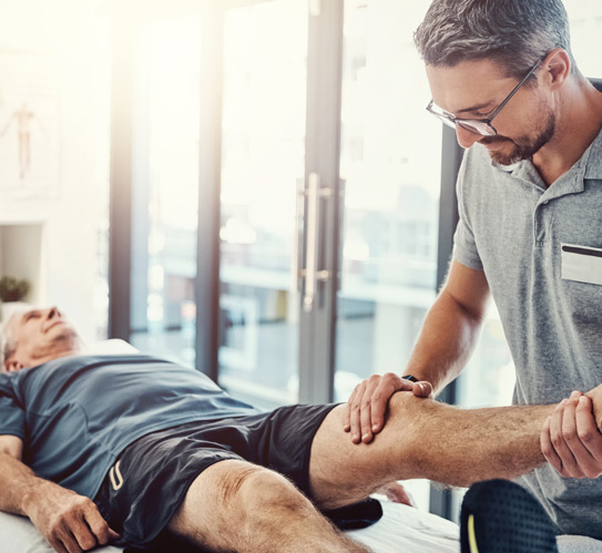 Therapist-helping-in-range-of-motion-exercises-to-patient