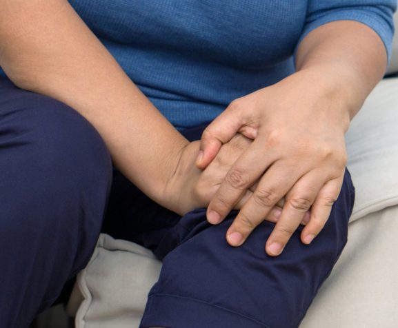 A-distressed-senior-woman-experiencing-sharp-knee-pain