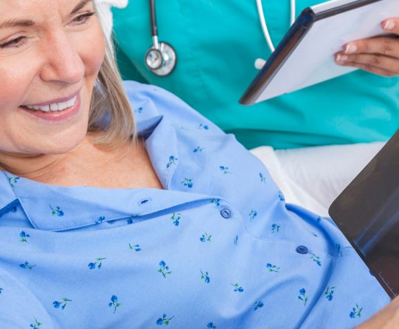 Male-doctor-and-female-patient-looking-at-hip-replacement-x-ray