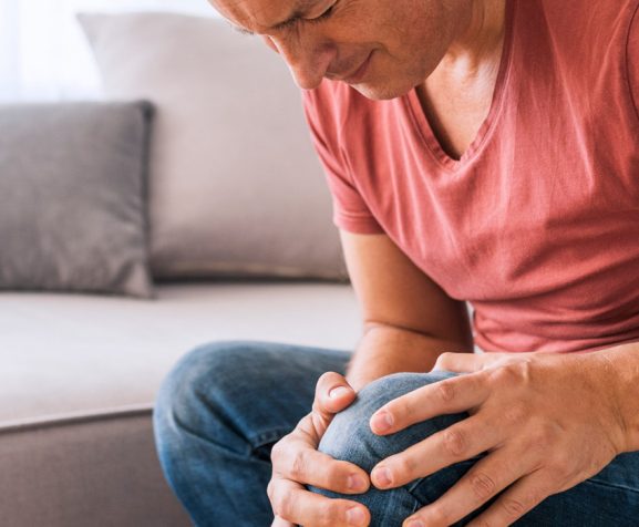 Mature-man-touching-his-painful-knee