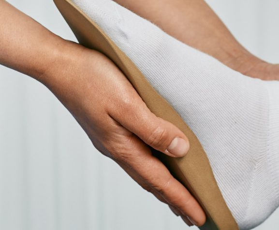 Orthopedist-fitting-orthopedic-insoles